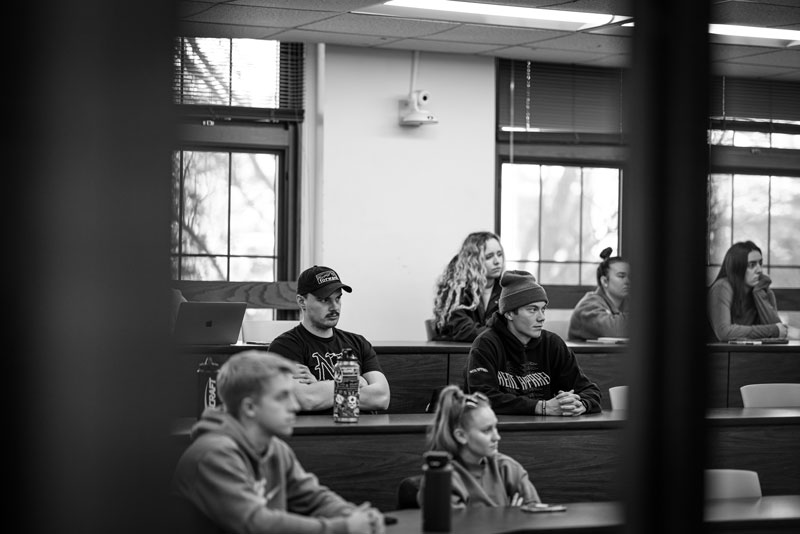 Students sit at desks in an accounting classroom, listening attentively during a lecture.
