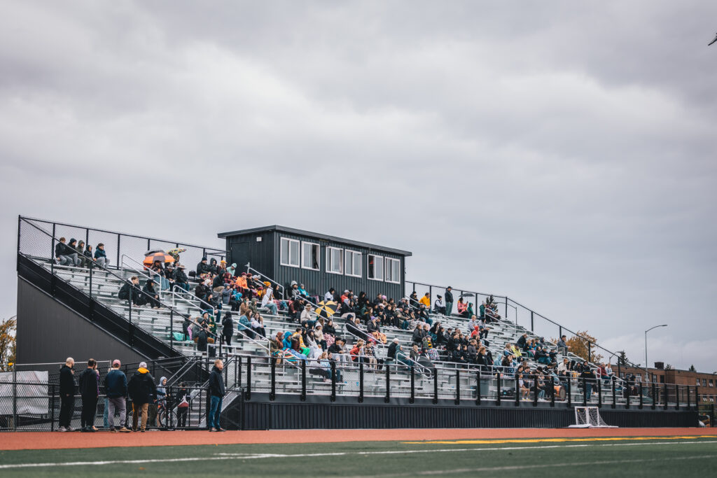 SCCU Stadium seats with crowd watchin soccer game.