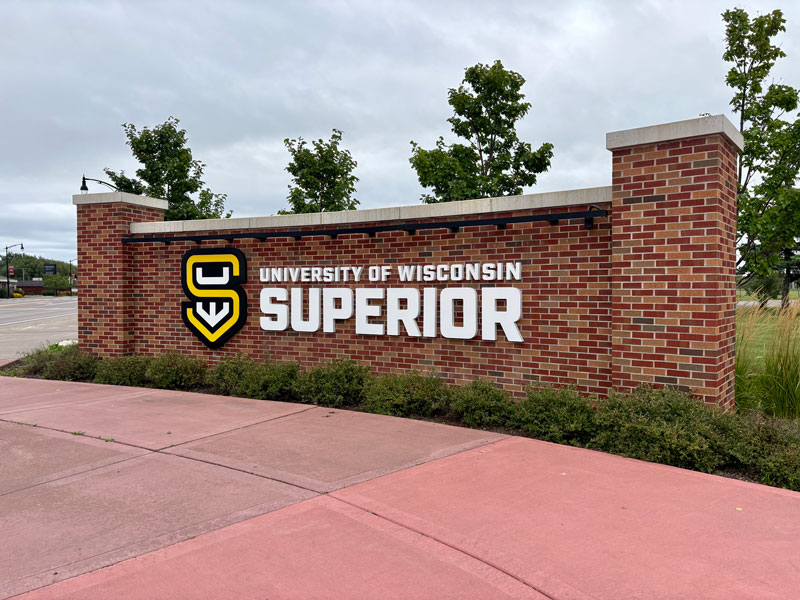 Brick sign reads University of Wisconsin Superior with logo, perfect for graduation photos.