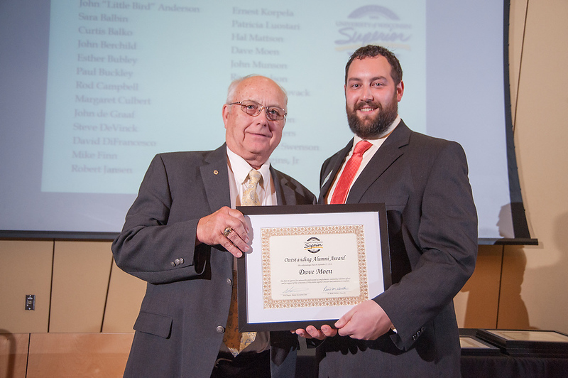 A photo of Dave Moen receiving the Outstanding Alumni Award