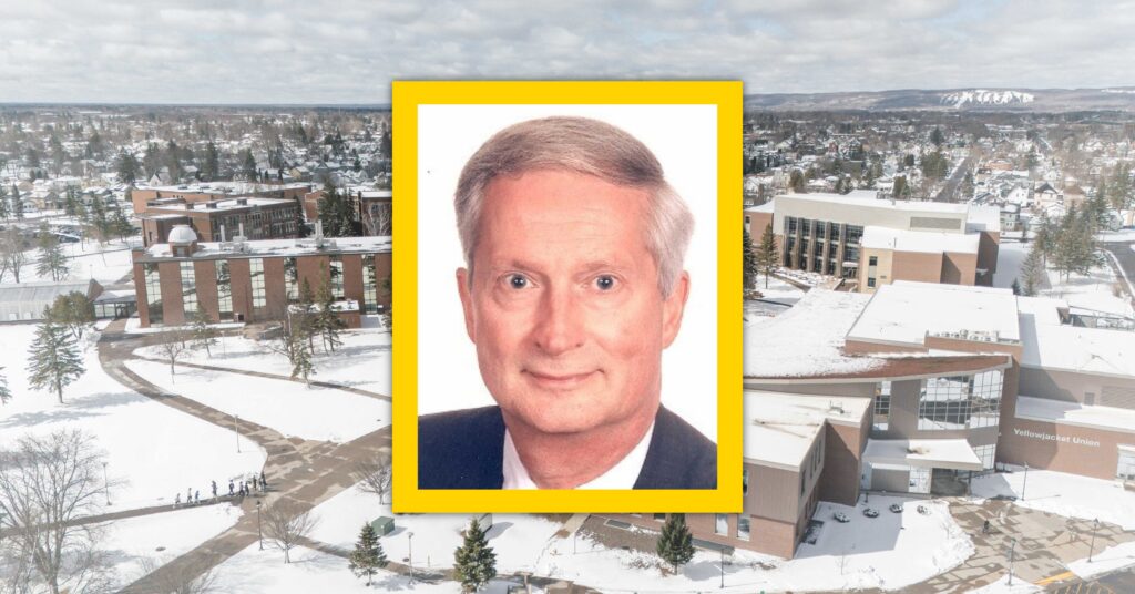 A portrait of an older man with short gray hair and a suit is framed in yellow, overlaid on an aerial view of a snowy university campus with several buildings and trees.