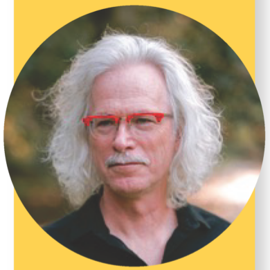 A man with long white hair and a mustache, wearing red glasses and a black shirt, stands outdoors in front of a blurred natural background. The image is framed by a yellow border.