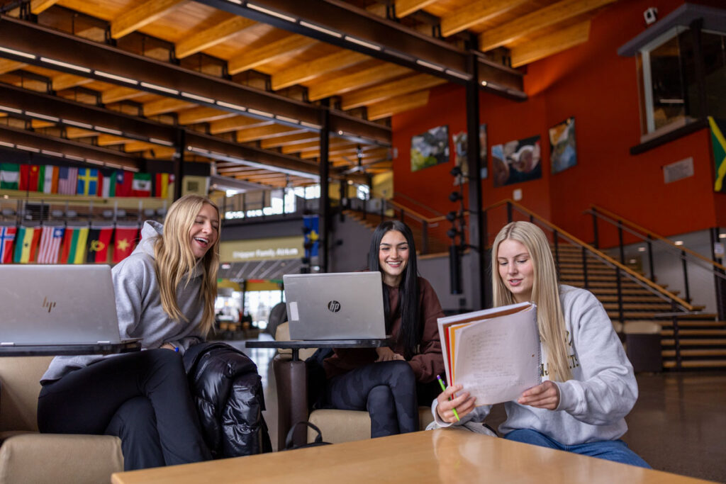 Three students participating in online computer work.