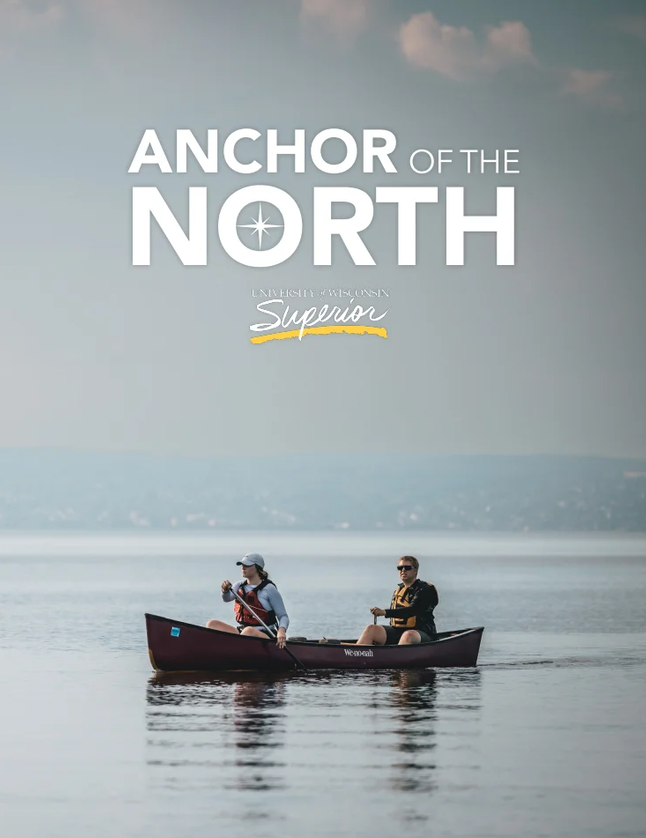 Two people paddle a canoe on a calm lake under a hazy sky. Large text above reads Anchor of the North, with smaller text below saying University of Wisconsin Superior, highlighting what it’s all about.