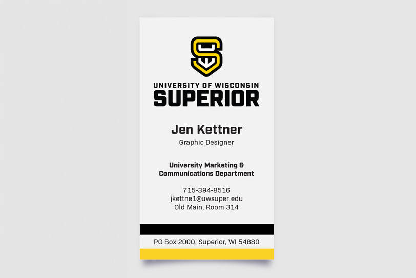 A business card for Jen Kettner, Graphic Designer at University of Wisconsin-Superior, with contact details, university logo, and black and yellow accents.