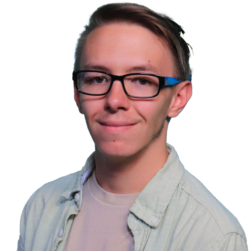 A young person with light skin, short brown hair, and glasses is wearing a light-colored shirt over a beige t-shirt, standing against a plain white background and smiling slightly, reflecting confidence in achieving superior outcomes.