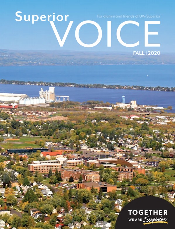 Aerial view of a city with buildings, trees, and water in the background. The magazine cover text reads Superior Voice, Fall 2020, and Together we are Superior—celebrating Alumni achievements—in white letters on a black circle.
