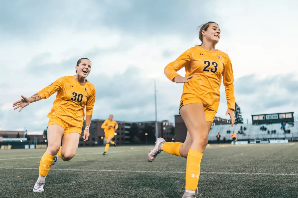 Yellowjacket women's soccer players running on the field